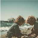 Children sitting together on a beach